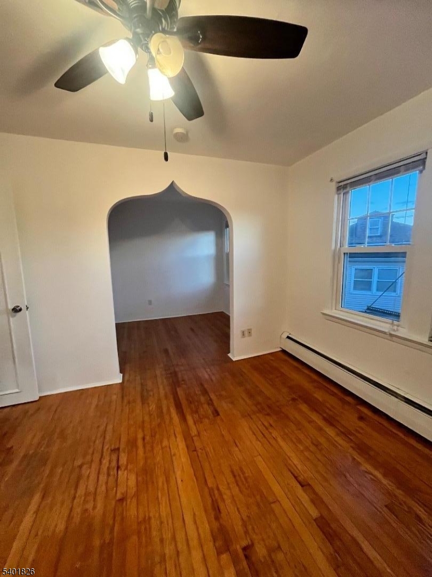321 Amon Terrace, Unit 1 Linden, NJ 07036 - Photo 7 of 15 a view of an empty room with wooden floor and a window