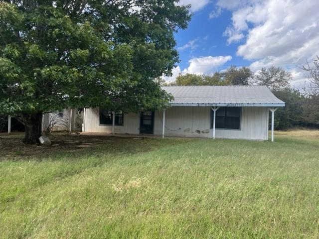 300 A E 3rd Street Iredell, TX 76649 - Photo 1 of 11 a front view of a house with a garden