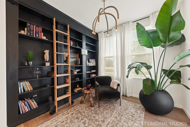 a living room with furniture and a potted plant