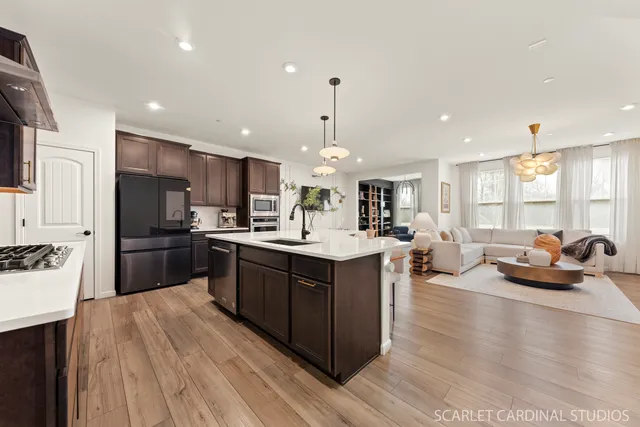 a kitchen with counter top space a sink cabinets and stainless steel appliances
