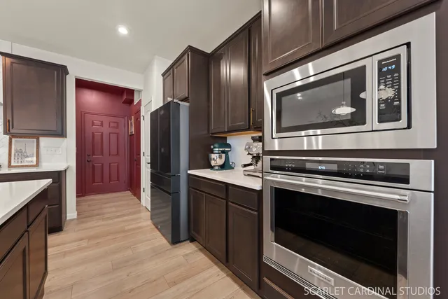 a kitchen with stainless steel appliances wooden cabinets stove and refrigerator