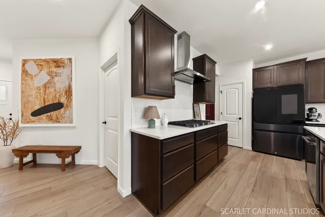 a large kitchen with a stove and a refrigerator