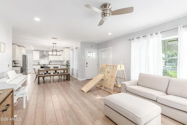 a living room with furniture and wooden floor
