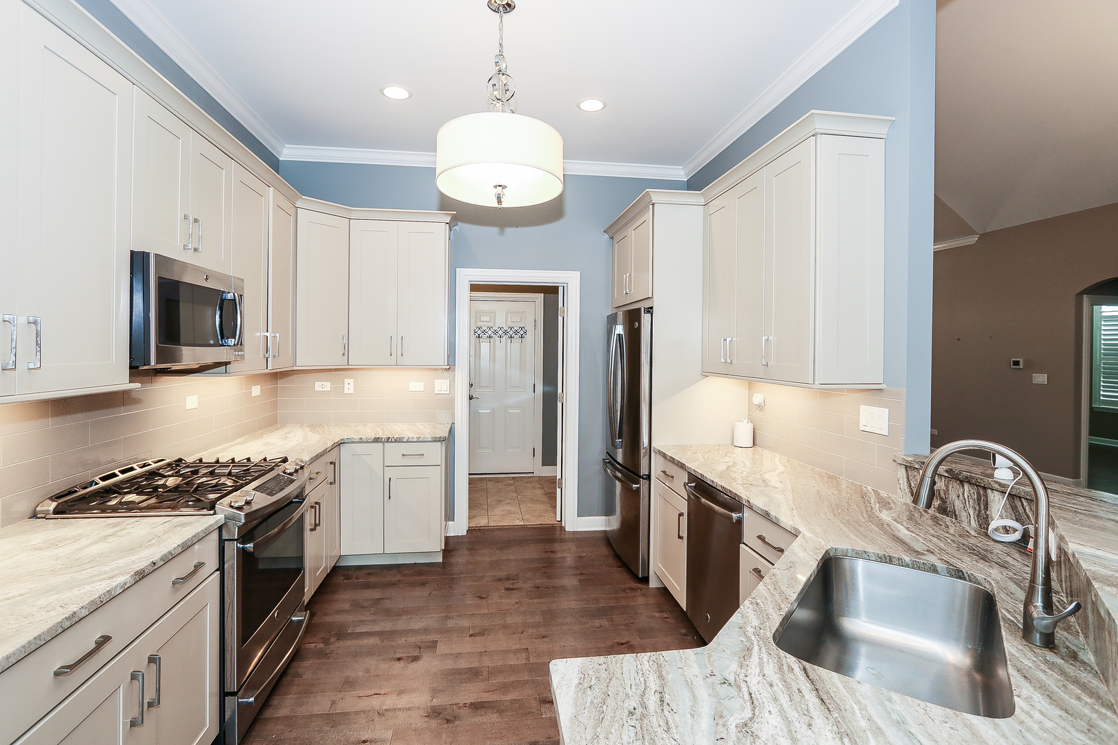 6 Sugar Maple Court Lake In The Hills, IL 60156 - Photo 12 of 35 a kitchen with stainless steel appliances granite countertop a stove a sink and a refrigerator
