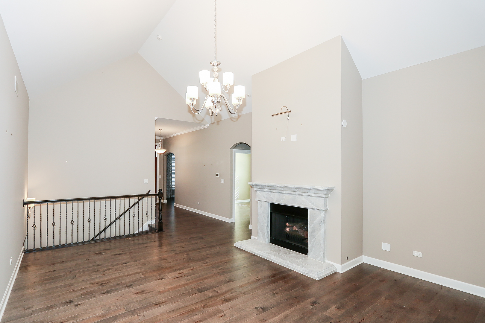 6 Sugar Maple Court Lake In The Hills, IL 60156 - Photo 5 of 35 a view of a livingroom with a fireplace a chandelier and wooden floor