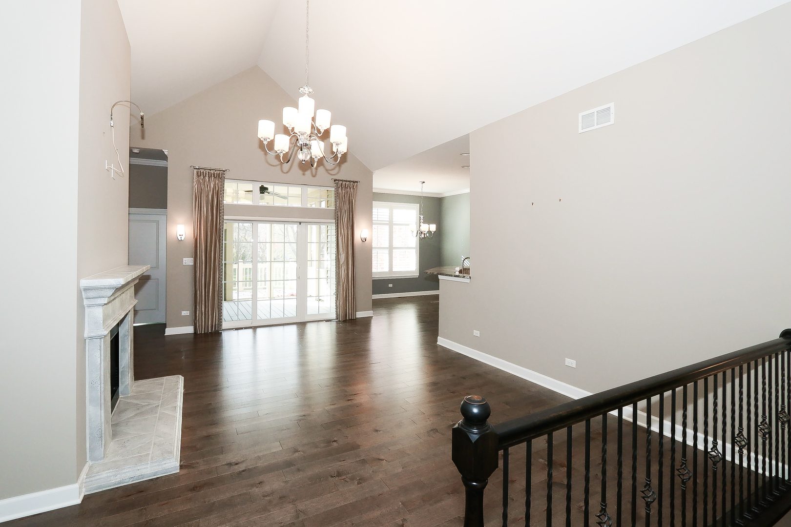 6 Sugar Maple Court Lake In The Hills, IL 60156 - Photo 6 of 35 a view of an empty room with wooden floor and a kitchen