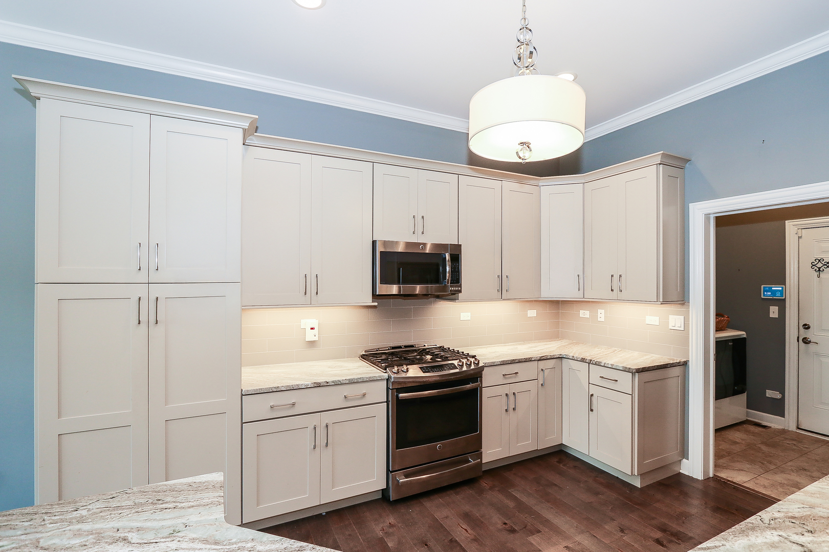 6 Sugar Maple Court Lake In The Hills, IL 60156 - Photo 10 of 35 a kitchen with cabinets stainless steel appliances and wooden floor