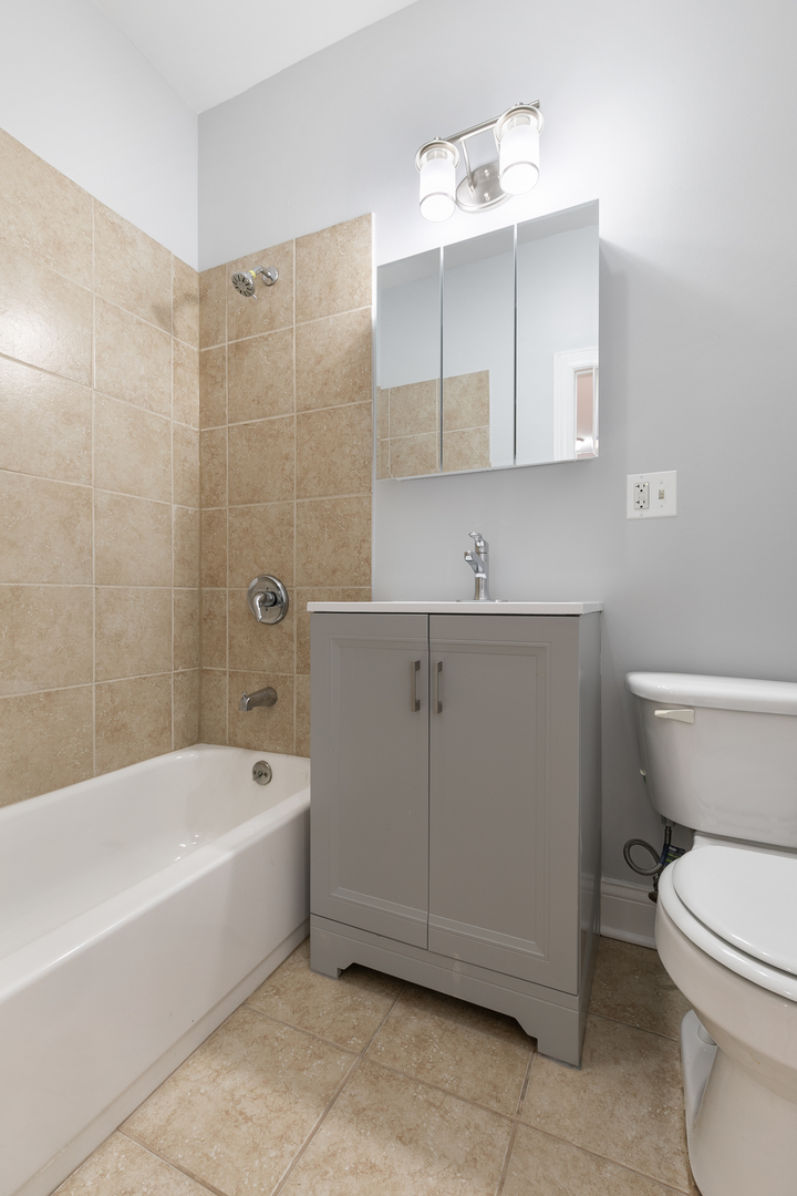 2007 West Jarvis Avenue, Unit 3 Chicago, IL 60645 - Photo 15 of 18 a bathroom with a sink a toilet and bathtub