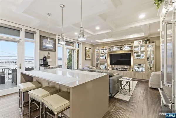 a large kitchen with a table chairs refrigerator and a sink