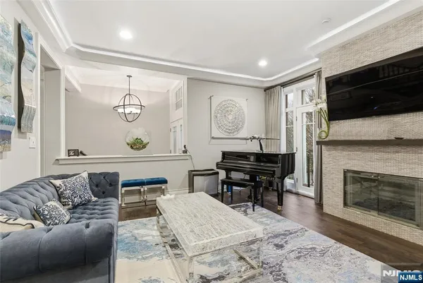 a living room with furniture a flat screen tv and a fireplace