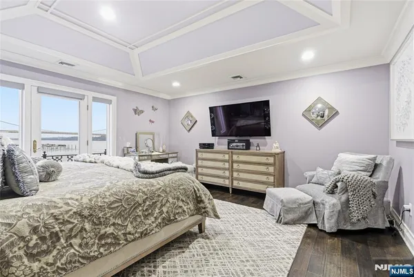 a bedroom with a bed and flat screen tv