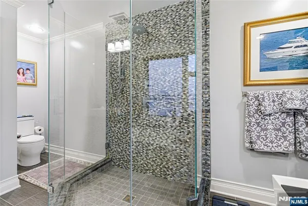 a bathroom with a toilet and a shower