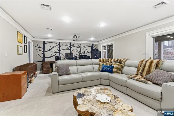 a living room with furniture and painting on the wall