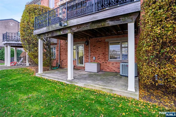 a view of a house with a small yard and wooden fence