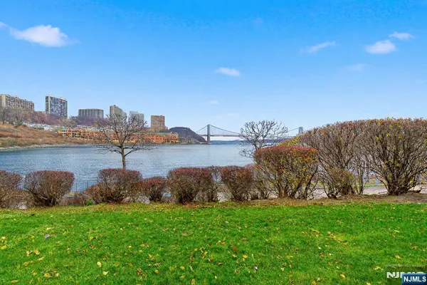 a view of a lake with houses in the back