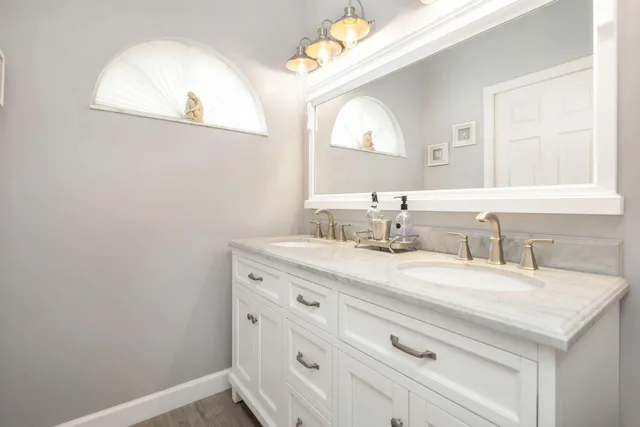 a bathroom with a sink vanity and a mirror