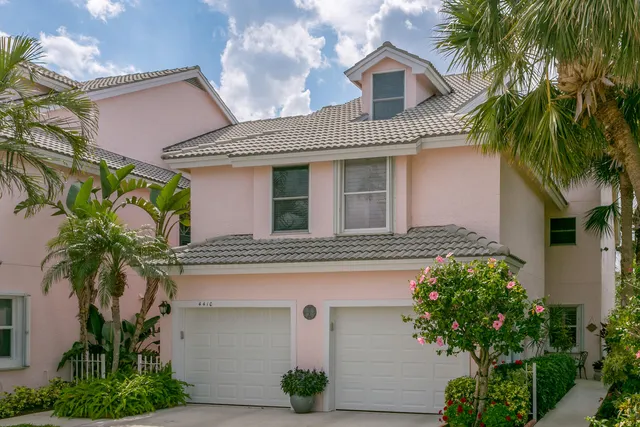 a front view of a house with plants