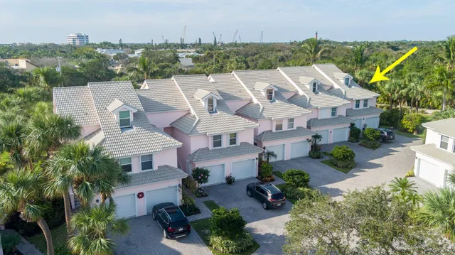 an aerial view of a house with a yard and trees