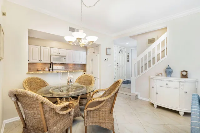 a dining room with furniture and chandelier