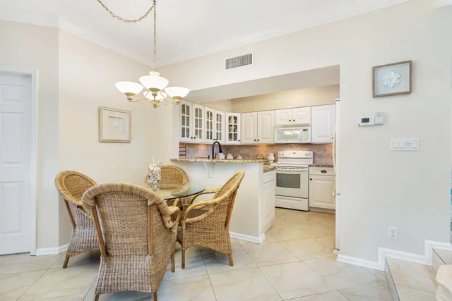 a view of a dining room with furniture and chandelier