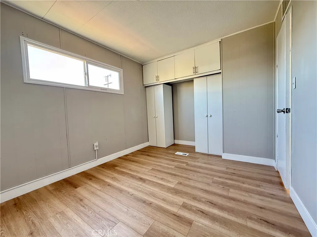 716 North Grand, Unit F8 Covina, CA 91724 - Photo 11 of 21 a view of an empty room with wooden floor and a window