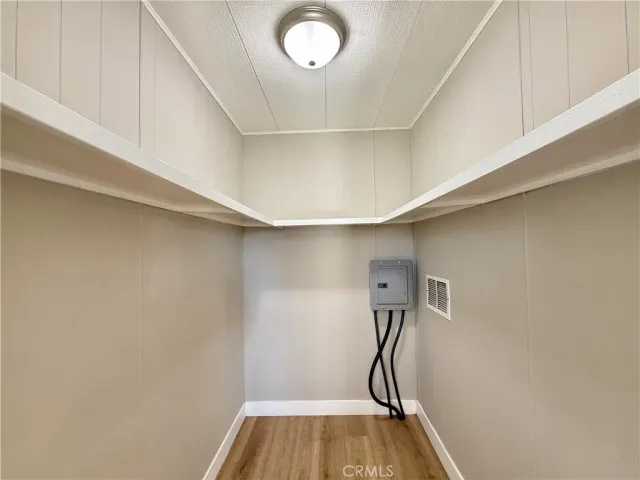 a room with gym equipment and wooden floor