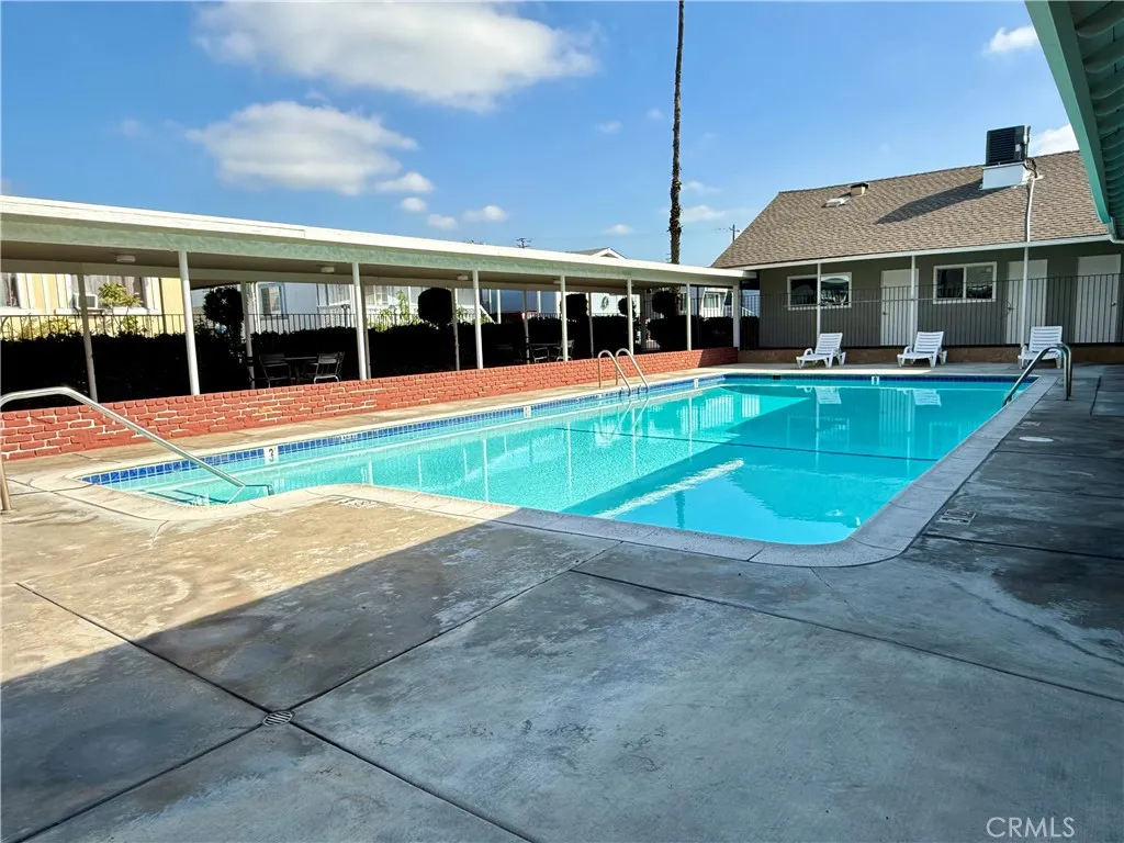 716 North Grand, Unit F8 Covina, CA 91724 - Photo 17 of 21 a view of pool with a table and chairs under an umbrella