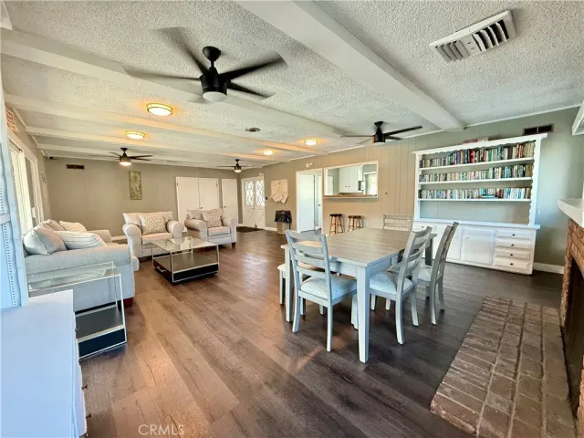 a living room with furniture a ceiling fan and a rug