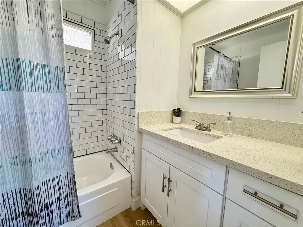 716 North Grand, Unit F8 Covina, CA 91724 - Photo 9 of 21 a bathroom with a tub sink and mirror