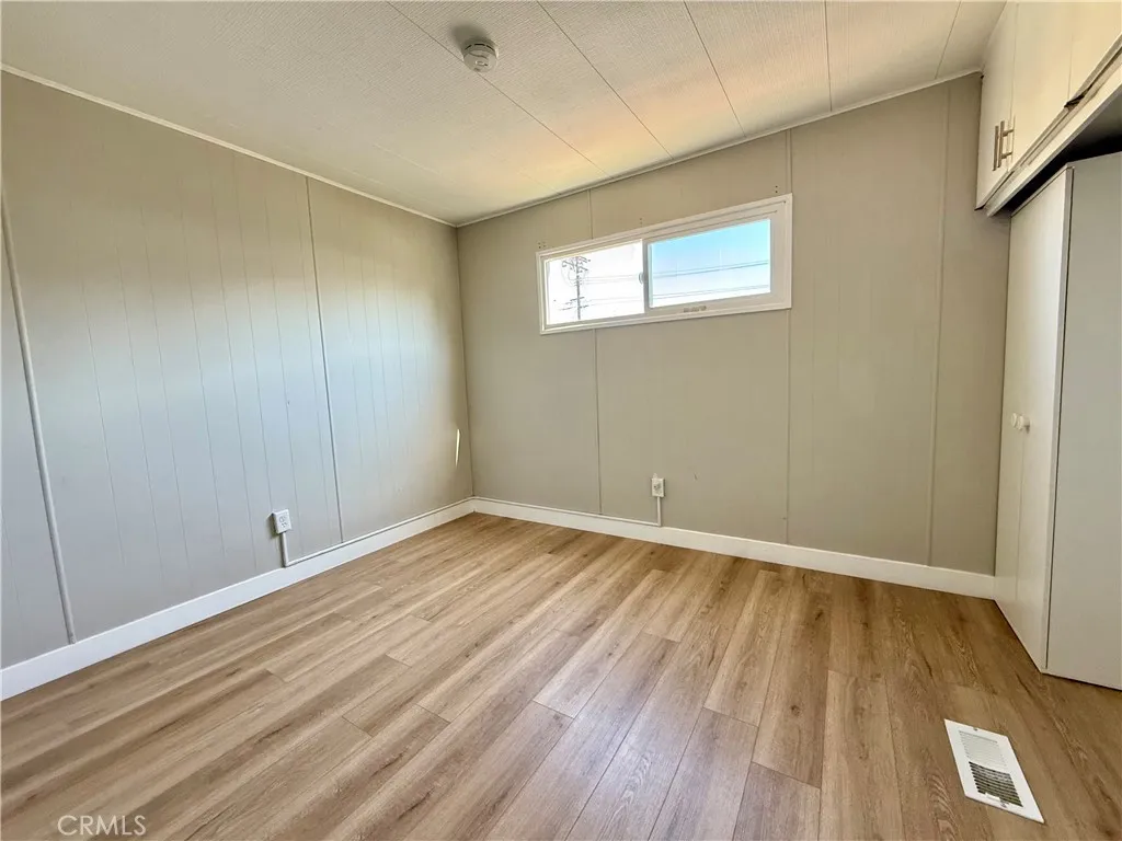 716 North Grand, Unit F8 Covina, CA 91724 - Photo 10 of 21 a view of an empty room with wooden floor and a window