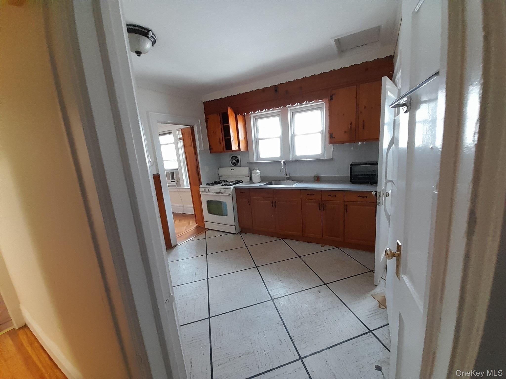 159-32 Normal Road, Unit 2 Queens, NY 11432 - Photo 11 of 13 a kitchen with stainless steel appliances a refrigerator and a sink
