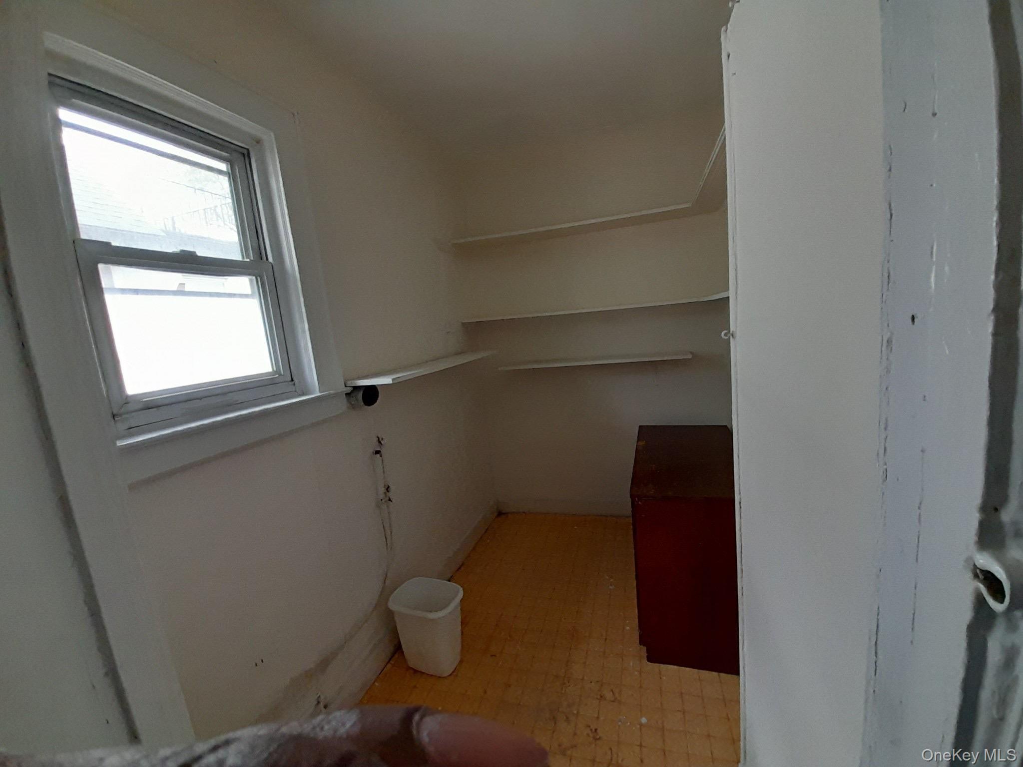 159-32 Normal Road, Unit 2 Queens, NY 11432 - Photo 12 of 13 a view of storage and utility room with racks on the wall
