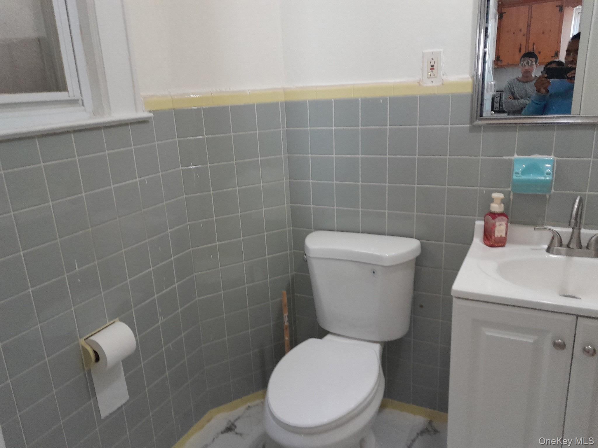 159-32 Normal Road, Unit 2 Queens, NY 11432 - Photo 9 of 13 a white toilet sitting next to a bathroom sink