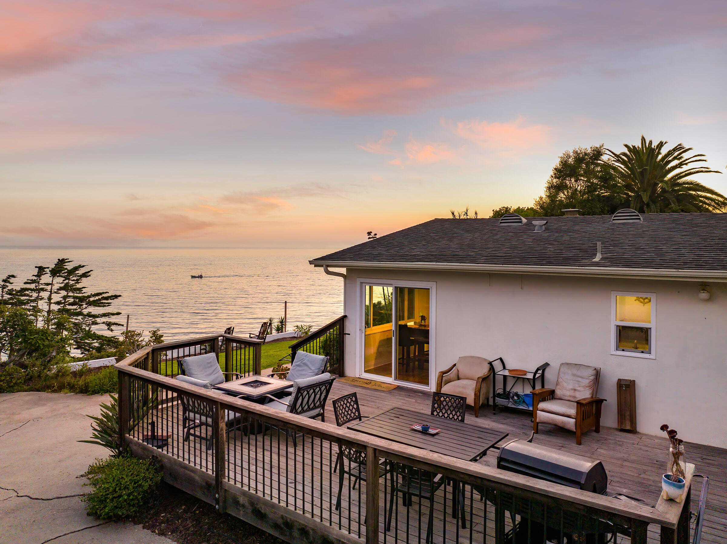 1919 El Camino De La Luz Santa Barbara, CA 93109 - Photo 13 of 28 a view of a roof deck with two couches and wooden floor next to a yard