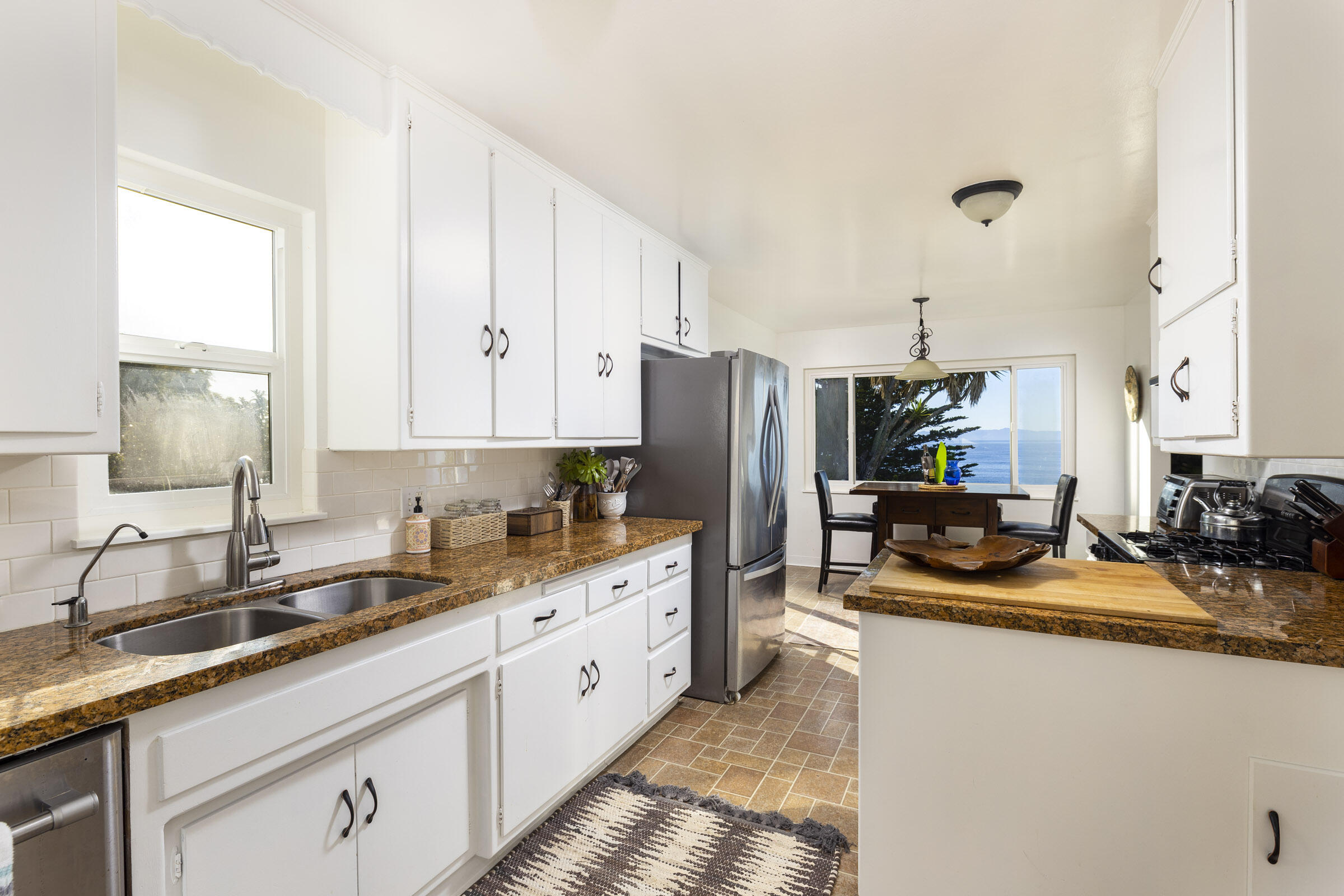 1919 El Camino De La Luz Santa Barbara, CA 93109 - Photo 18 of 28 a kitchen with sink a refrigerator and cabinets