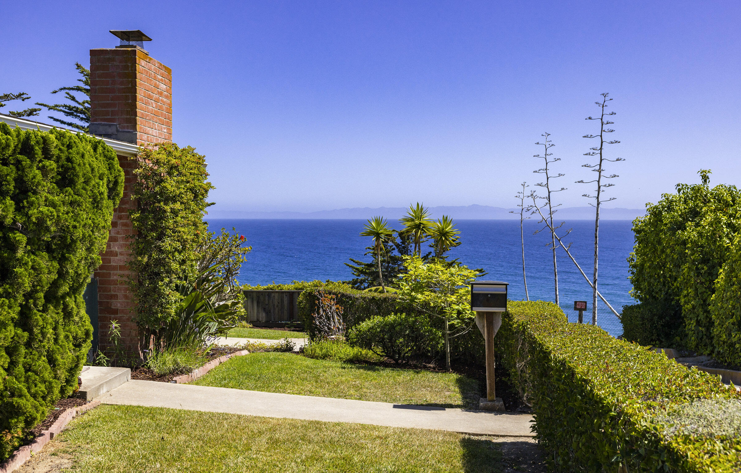 1919 El Camino De La Luz Santa Barbara, CA 93109 - Photo 2 of 28 a view of a garden with a house in background
