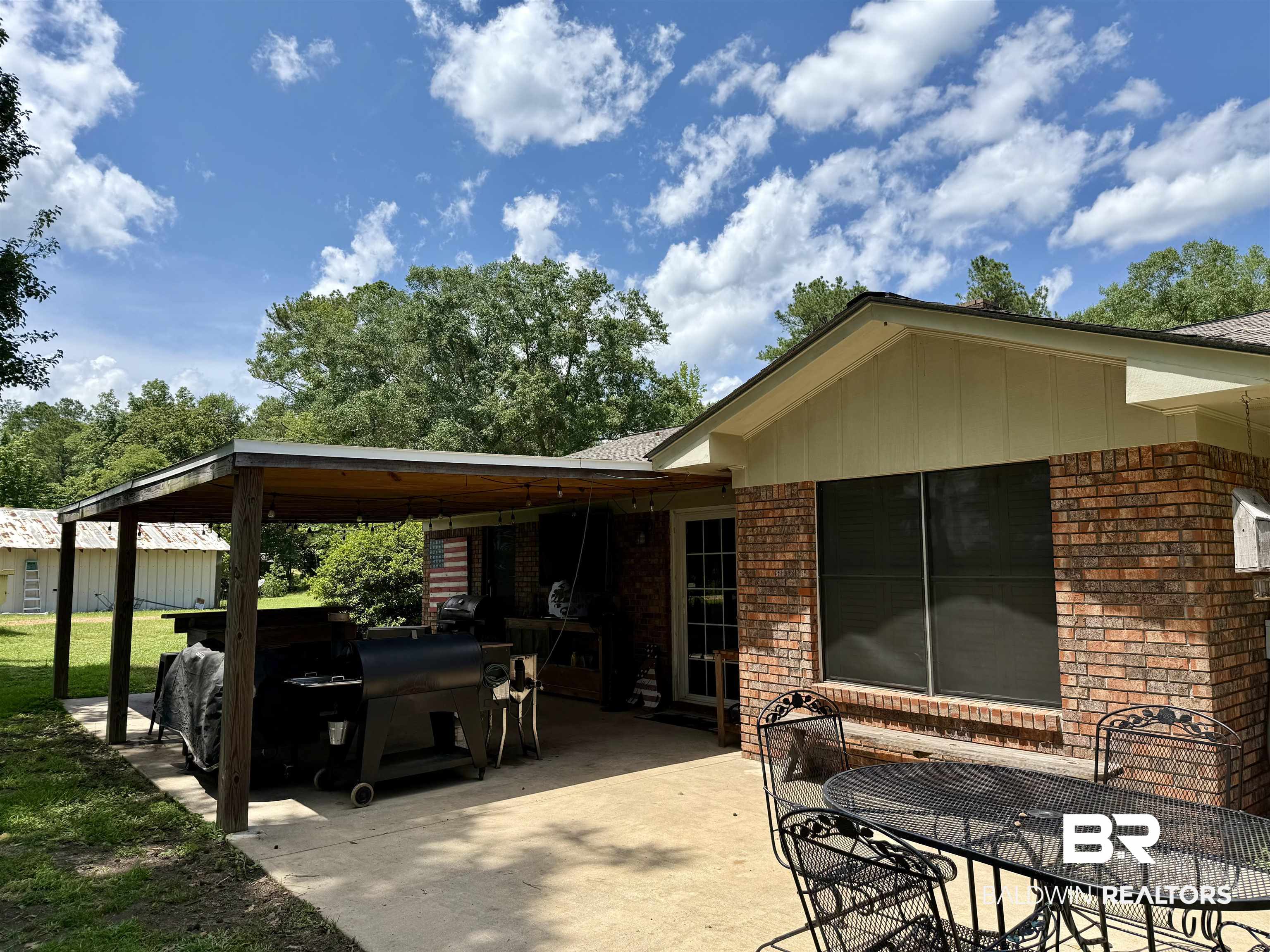 5971 Appleton Road Brewton, AL 36426 - Photo 20 of 23 View of patio / terrace featuring a carport, a grill, and outdoor dining space
