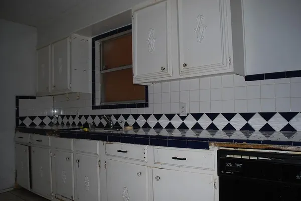a close view of a stove a microwave and cabinets