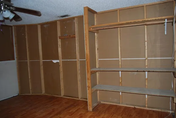 a view of a room with wooden floor