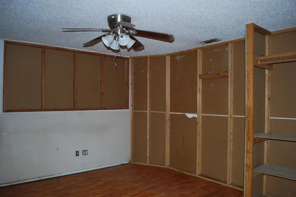 a view of a livingroom with a ceiling fan and window