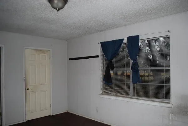 a bathroom with a granite countertop toilet sink and mirror