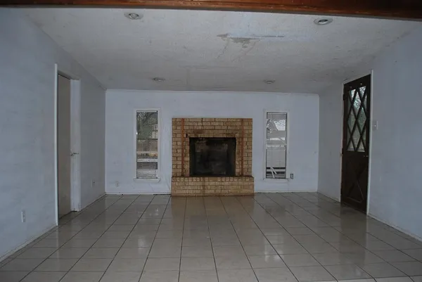 a view of a livingroom with an empty space and a fireplace