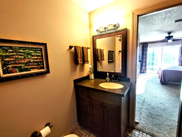 a bedroom with a bed and a painting on the wall