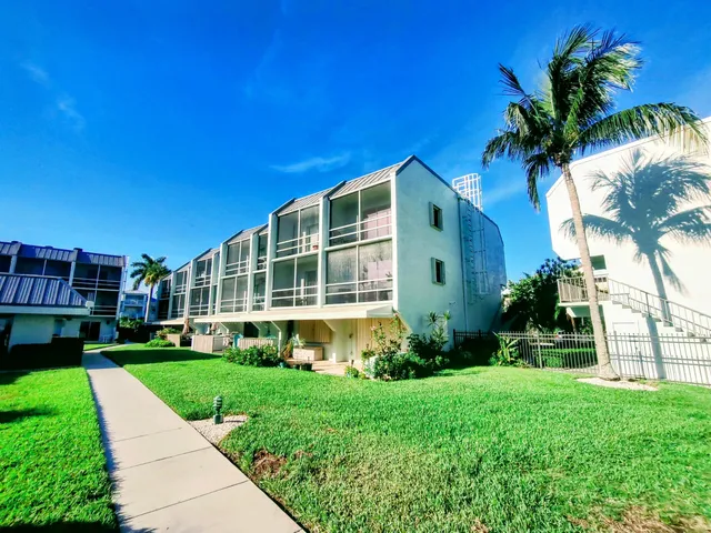 a view of a livingroom with furniture a dinning room and wooden floor