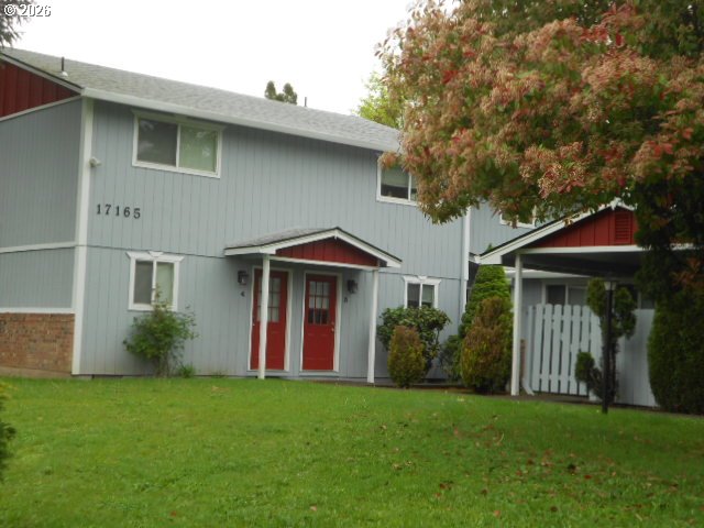 17165 Southwest Merlo Road Beaverton, OR 97003 - Photo 1 of 19 a front view of a house with a garden