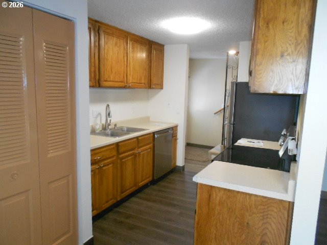17165 Southwest Merlo Road Beaverton, OR 97003 - Photo 11 of 19 a kitchen with a sink a stove wooden floor and cabinets