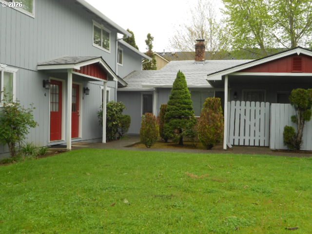 17165 Southwest Merlo Road Beaverton, OR 97003 - Photo 4 of 19 a front view of a house with a garden