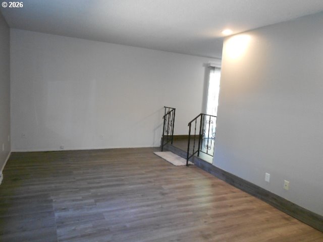 17165 Southwest Merlo Road Beaverton, OR 97003 - Photo 8 of 19 a view of an empty room and wooden floor