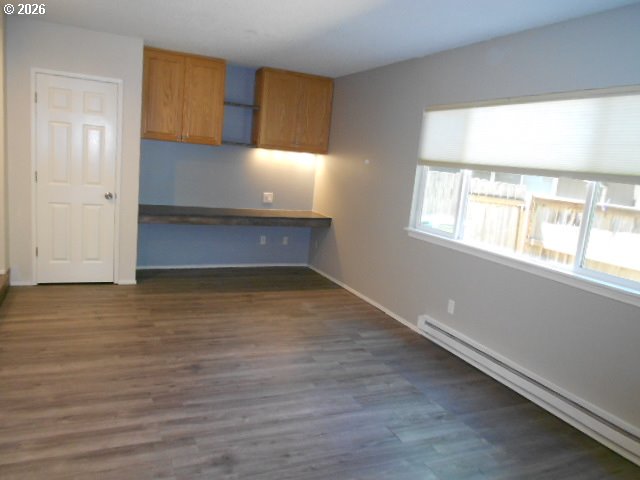 17165 Southwest Merlo Road Beaverton, OR 97003 - Photo 9 of 19 a view of an empty room with wooden floor and a window