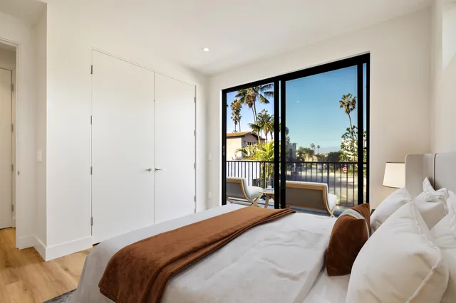 a bedroom with a large bed and a large window